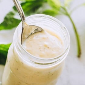 Low Carb and Keto Homemade Alfredo Sauce with Basil Pesto in a jar.
