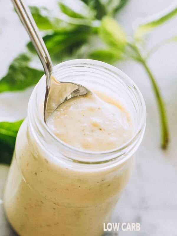 Low Carb and Keto Homemade Alfredo Sauce with Basil Pesto in a jar.
