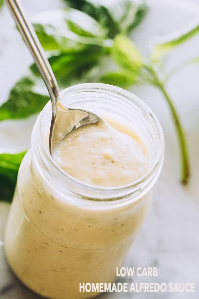 Low Carb and Keto Homemade Alfredo Sauce with Basil Pesto in a jar. 