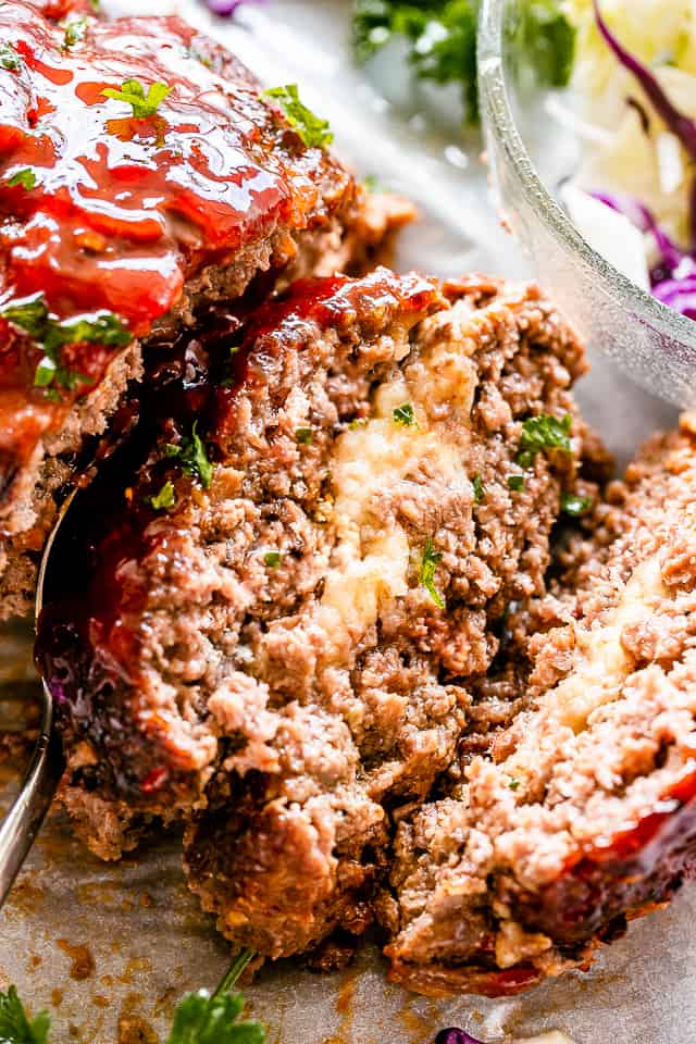 Slice of meatloaf stuffed with melted mozzarella cheese.