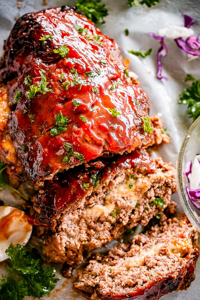 Sliced cheesy Meatloaf on a serving tray.
