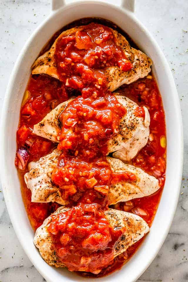 Salsa poured over chicken breasts.