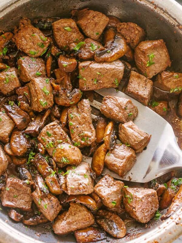 Skillet with steak and mushrooms.