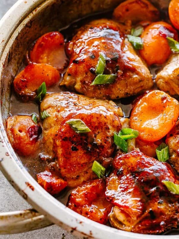 Barbecue Apricot chicken thighs in a skillet.