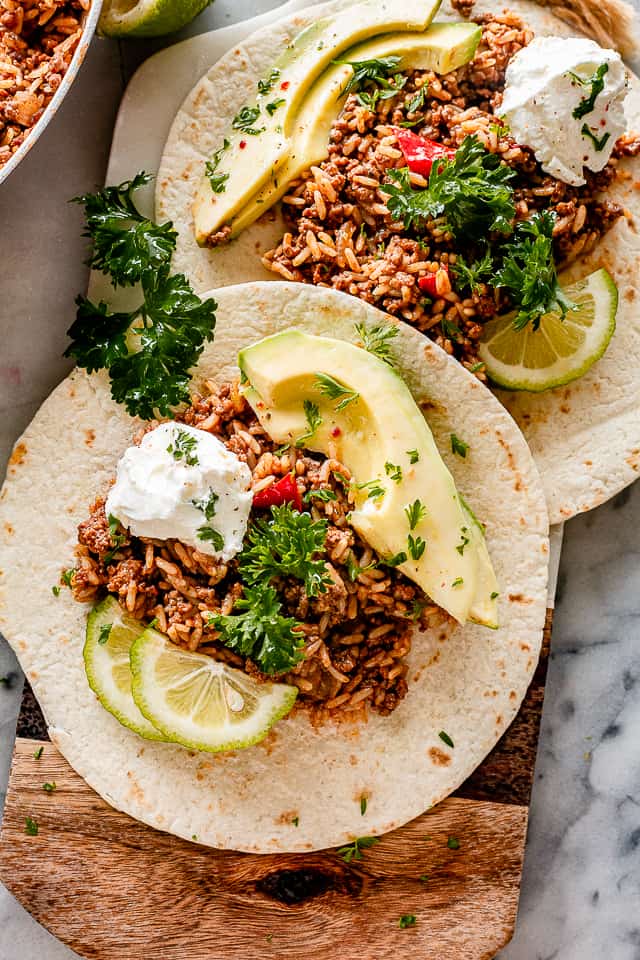Tacos filled with ground beef and avocados.