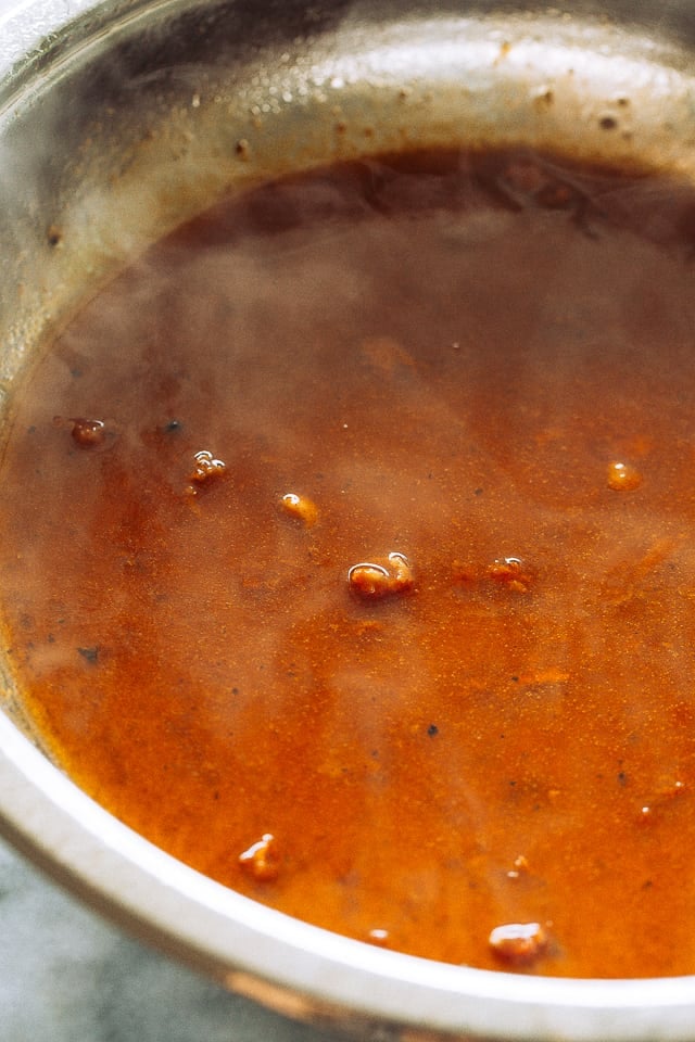 Apricot jam and barbecue sauce in a skillet.