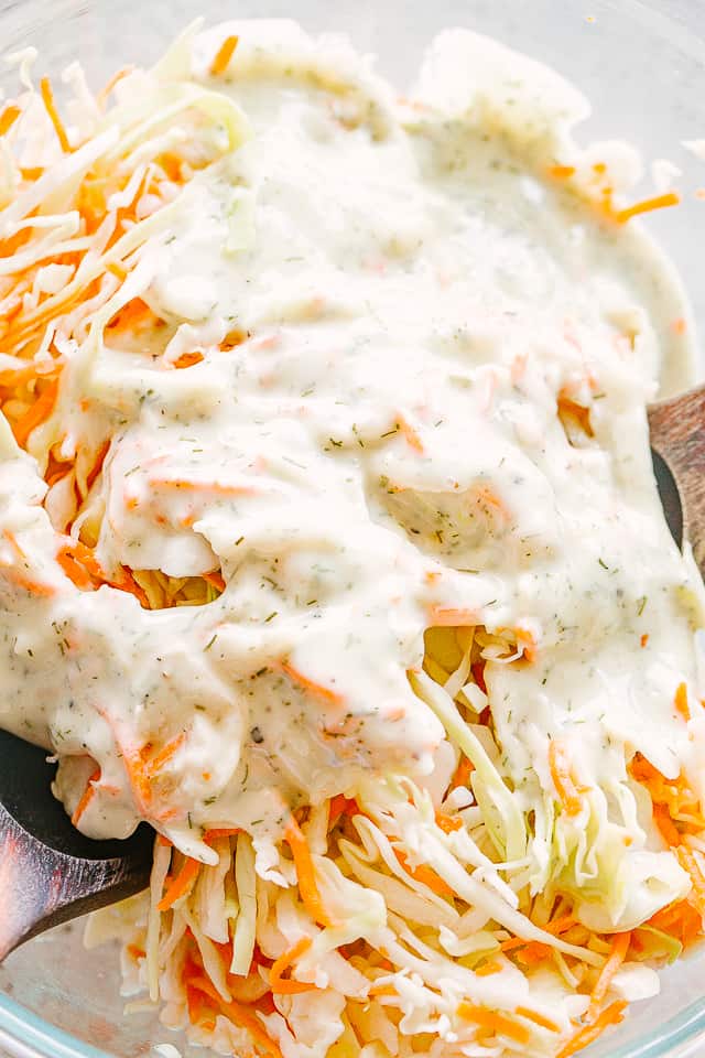 Mayonnaise salad dressing poured over shredded cabbage and carrots.