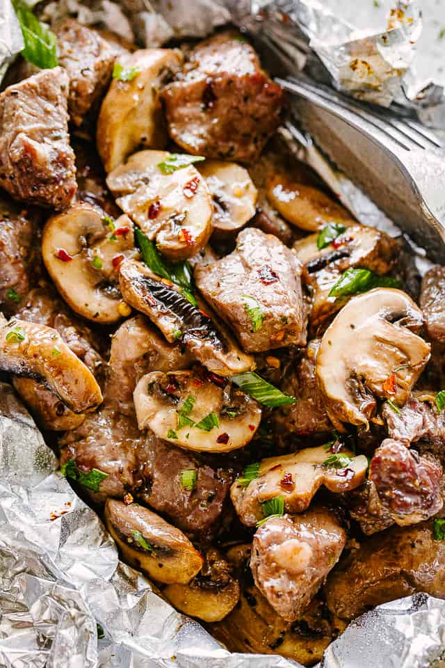 Steak and mushrooms in foil packs.