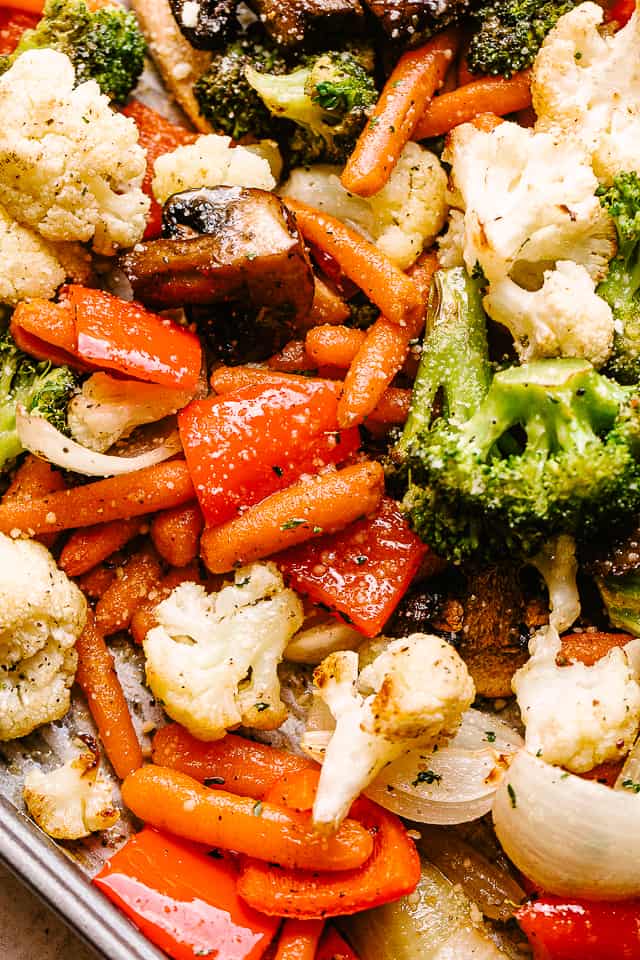 Close-up photo of roasted broccoli, cauliflower, bell peppers, carrots, and mushrooms.