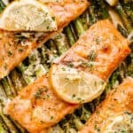 Baked salmon fillets with lemon slices.