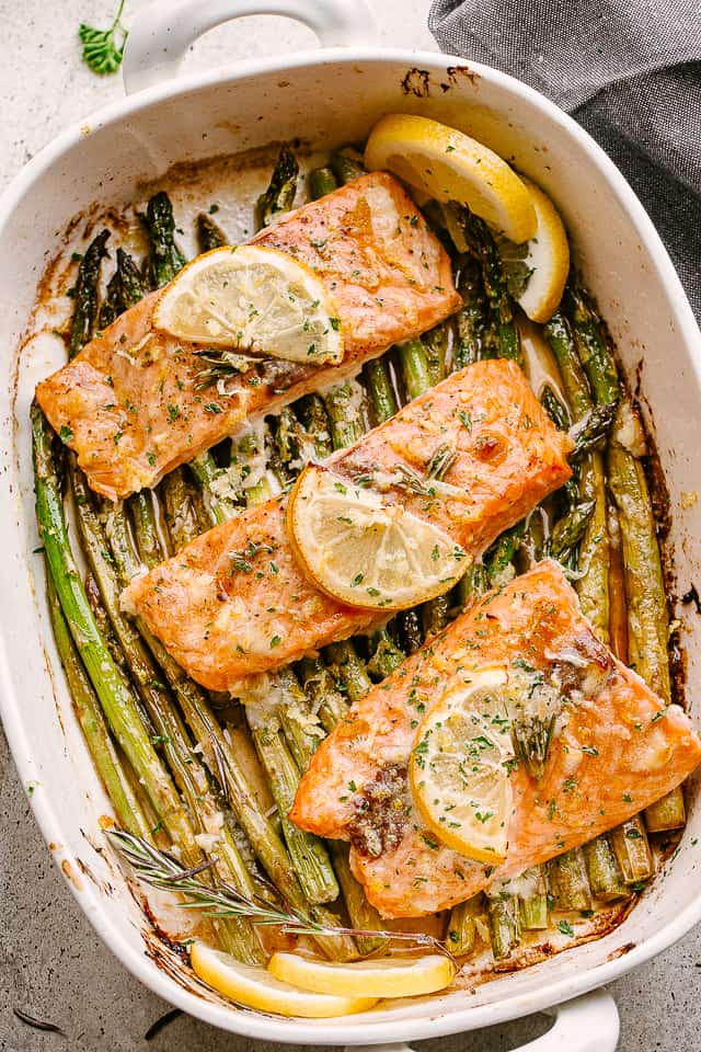 Baked salmon and asparagus in a baking dish.