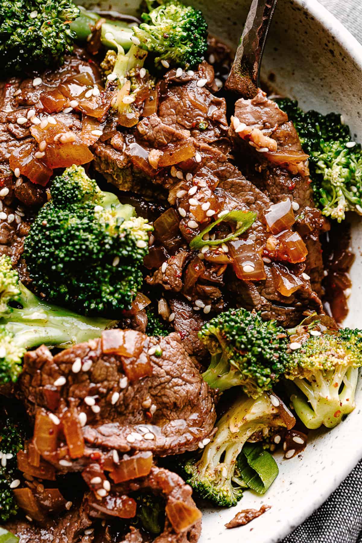 up close shot of Beef and Broccoli garnished with sesame seeds.