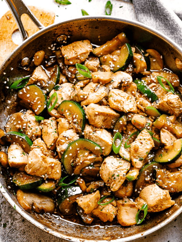 photo of a Skillet with stir fried chicken, mushrooms, and zucchini.