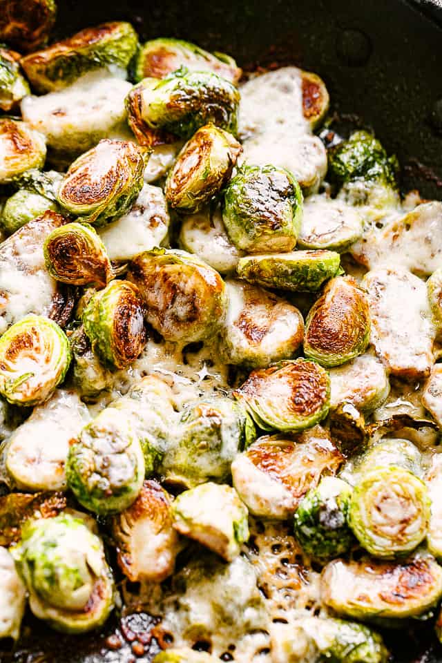 Brussels sprouts cooking in a skillet.