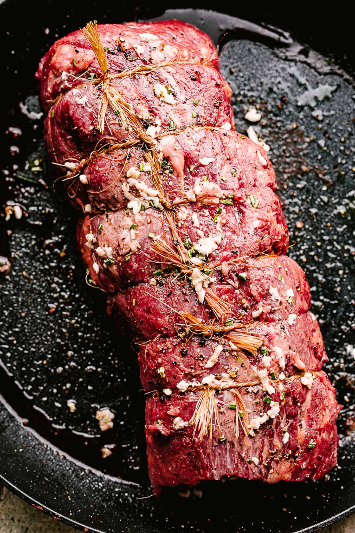 Raw Beef Tenderloin tied with kitchen twine.