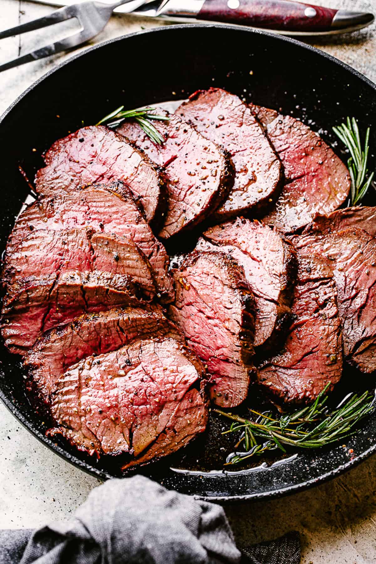 Cooked beef tenderloin in a skillet.