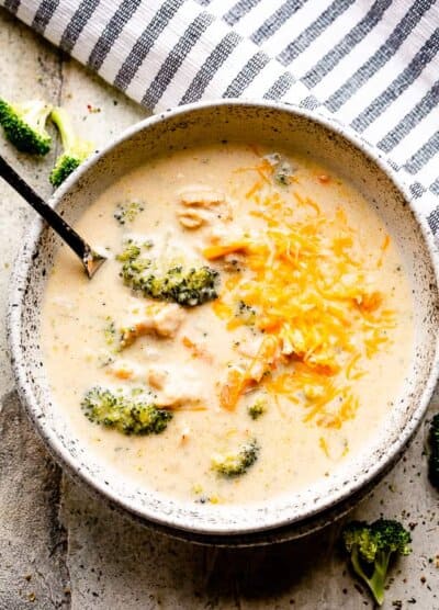 instant pot broccoli cheese soup in a soup bowl with spoon.