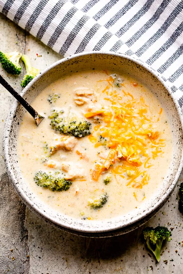 instant pot broccoli cheese soup in a soup bowl with spoon.
