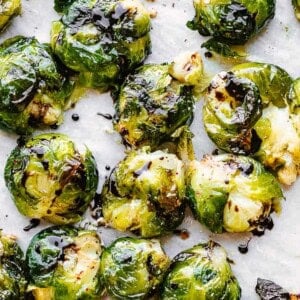 Balsamic glaze drizzled over smashed brussel sprouts.