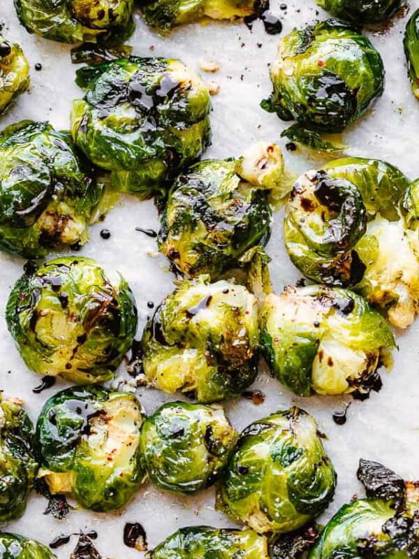 Balsamic glaze drizzled over smashed brussel sprouts.