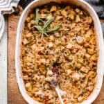 turkey wild rice casserole in a baking dish with a big spoon.