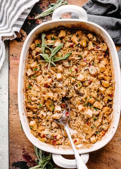 turkey wild rice casserole in a baking dish with a big spoon.