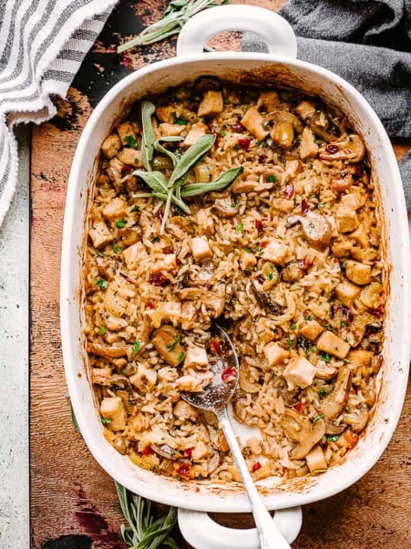turkey wild rice casserole in a baking dish with a big spoon.