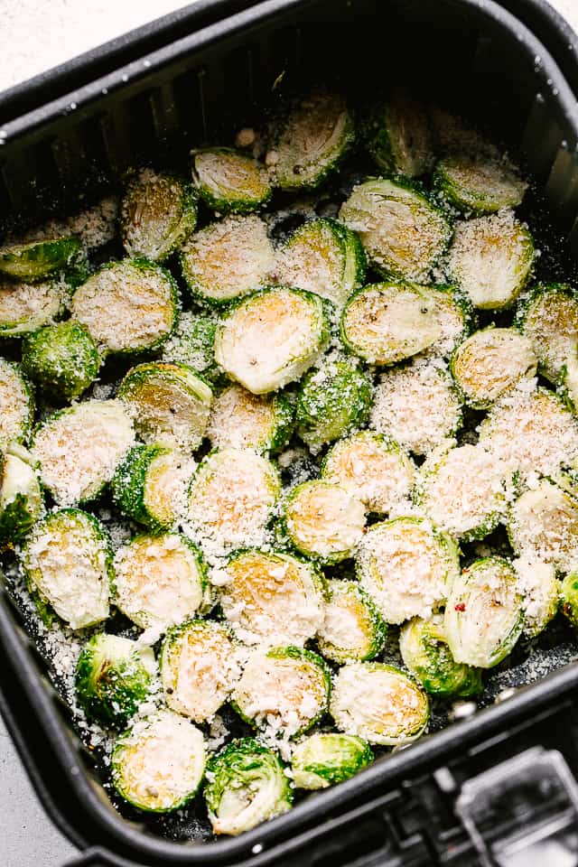 parmesan cheese sprinkled over halved brussel sprouts