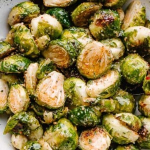 A bowl of cooked, caramelized brussel sprouts.
