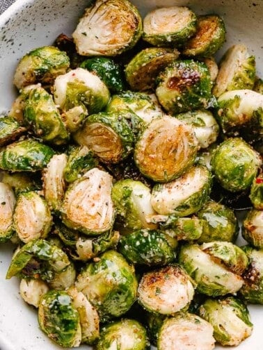 A bowl of cooked, caramelized brussel sprouts.