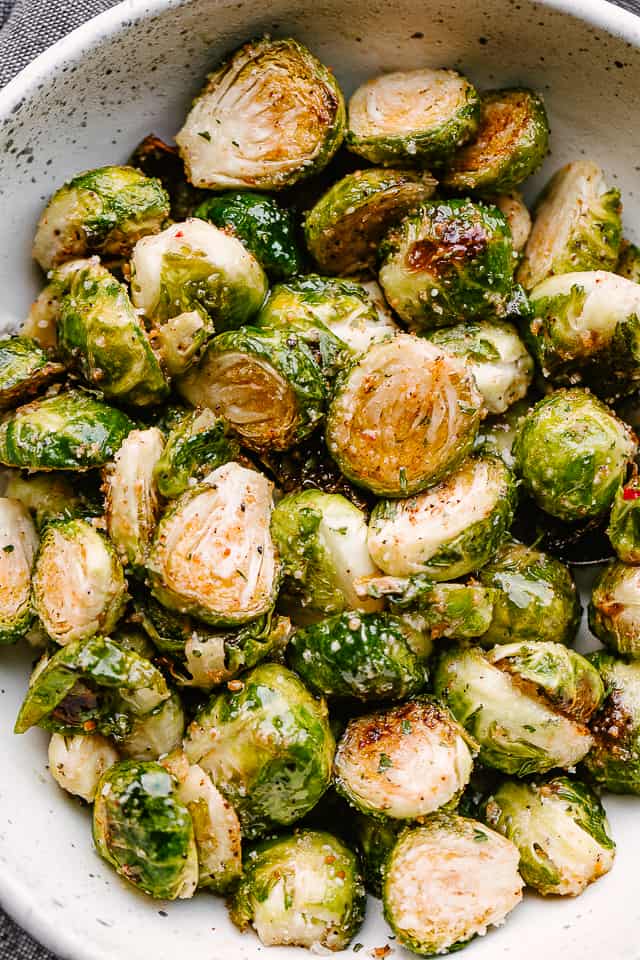 A bowl of cooked, caramelized brussel sprouts.