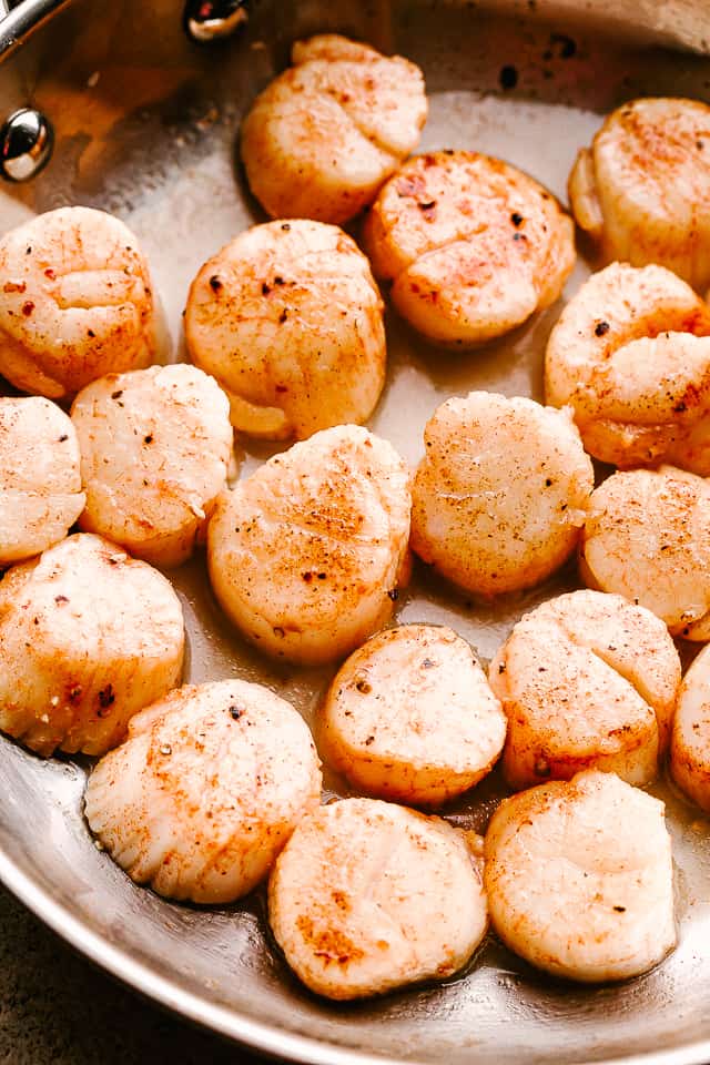 raw scallops in a skillet