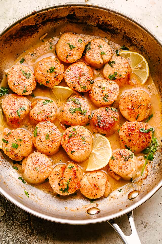 scallops cooked in a skillet with garlic, butter, and lemon juice