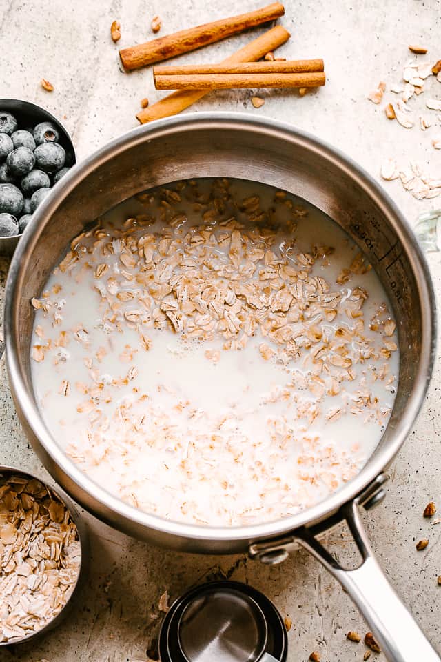 cooking oats and milk in a saucepan