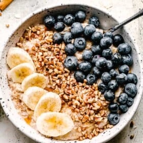 bowl of homemade oatmeal topped with berries and nuts