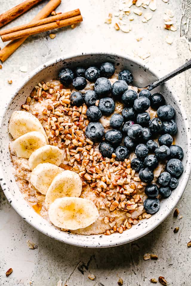 bowl of homemade oatmeal topped with berries and nuts