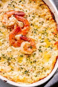 baked shrimp dip topped with cooked shrimp