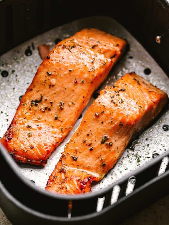 Cooked salmon fillets in an air fryer basket