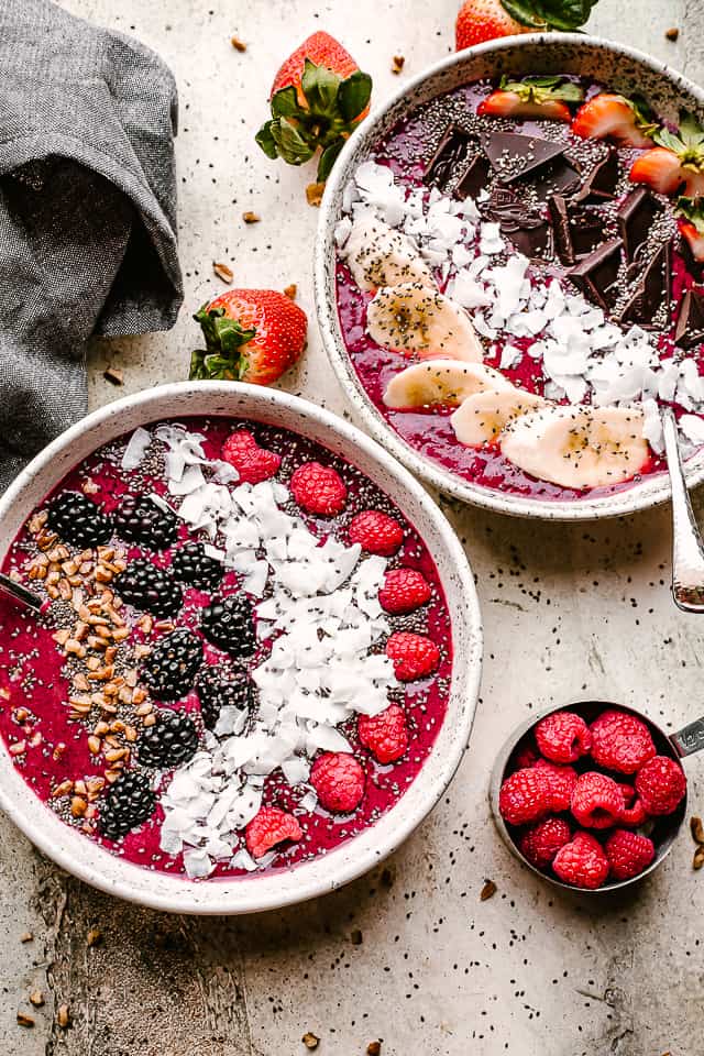 Two bowls filled with acai blend smoothies.