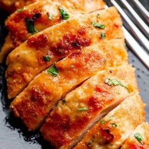 fried sliced chicken on a black plate