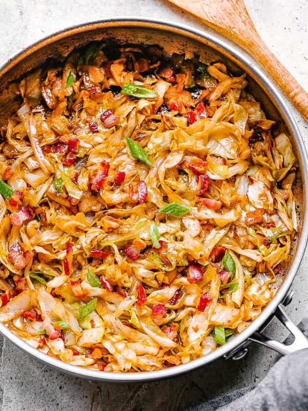 Frying sliced cabbage and bacon in a skillet.