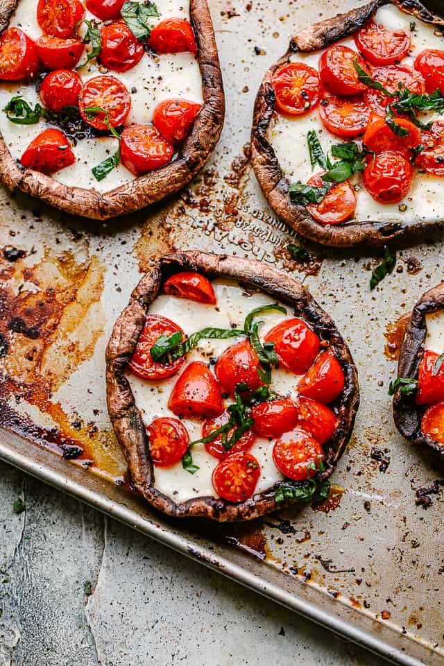 Baked stuffed mushrooms with cherry tomatoes and melted mozzarella cheese.