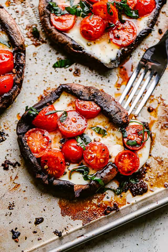 cutting into caprese stuffed mushrooms