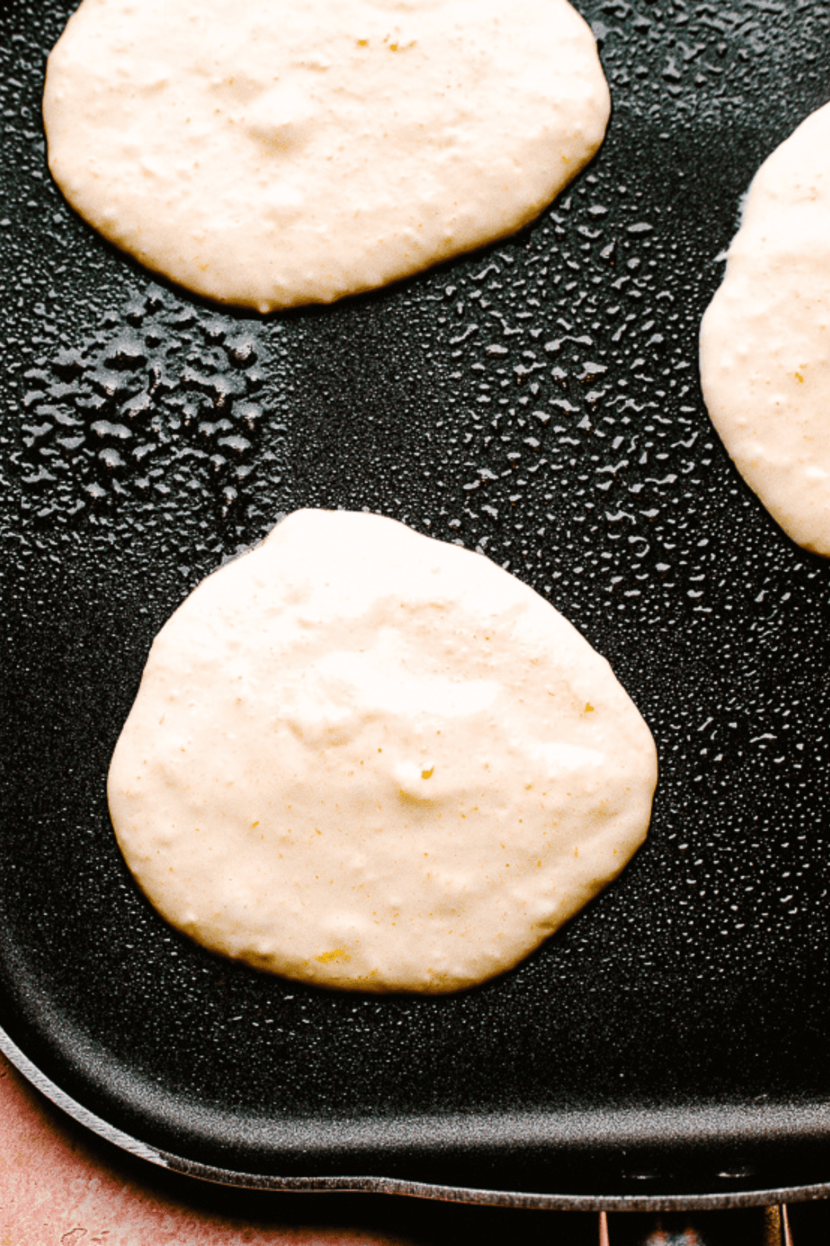 cooking pancakes on a griddle.