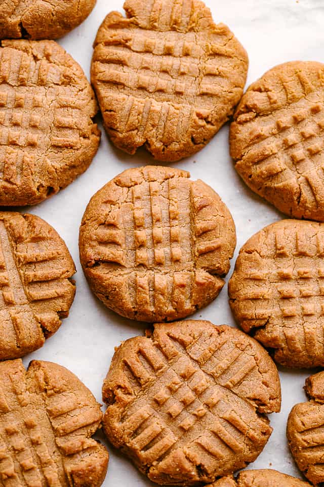 Peanut butter cookies on a parchment-lined baking sheet.