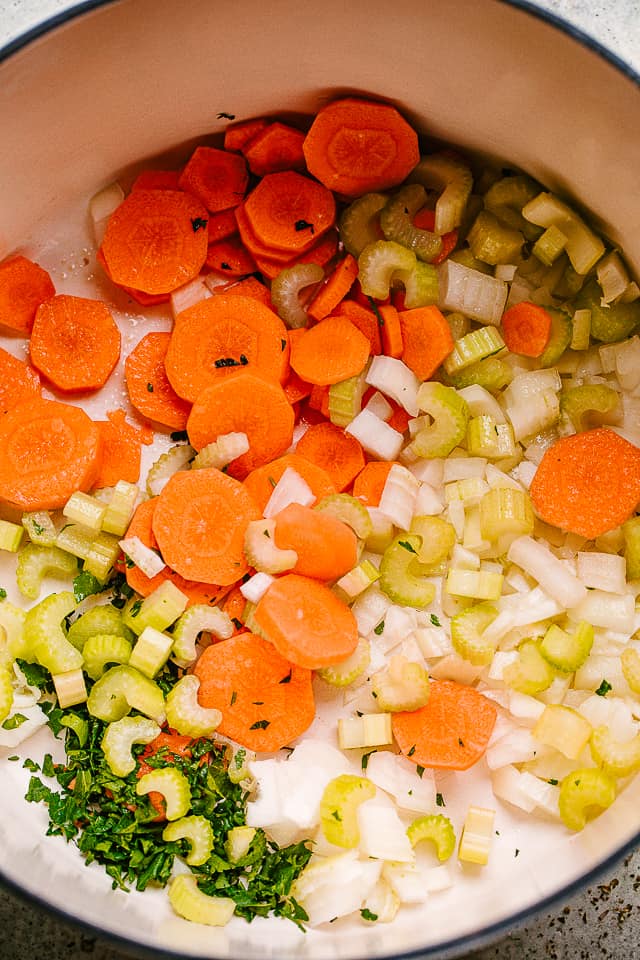 Frying carrots, onions, celery, and parsley to make White Bean Soup.
