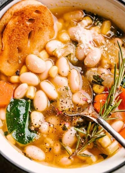 White Bean Soup in a bowl with sliced bread.