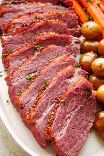 Crock Pot corned beef sliced and served with potatoes and carrots