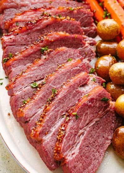 Crock Pot corned beef sliced and served with potatoes and carrots