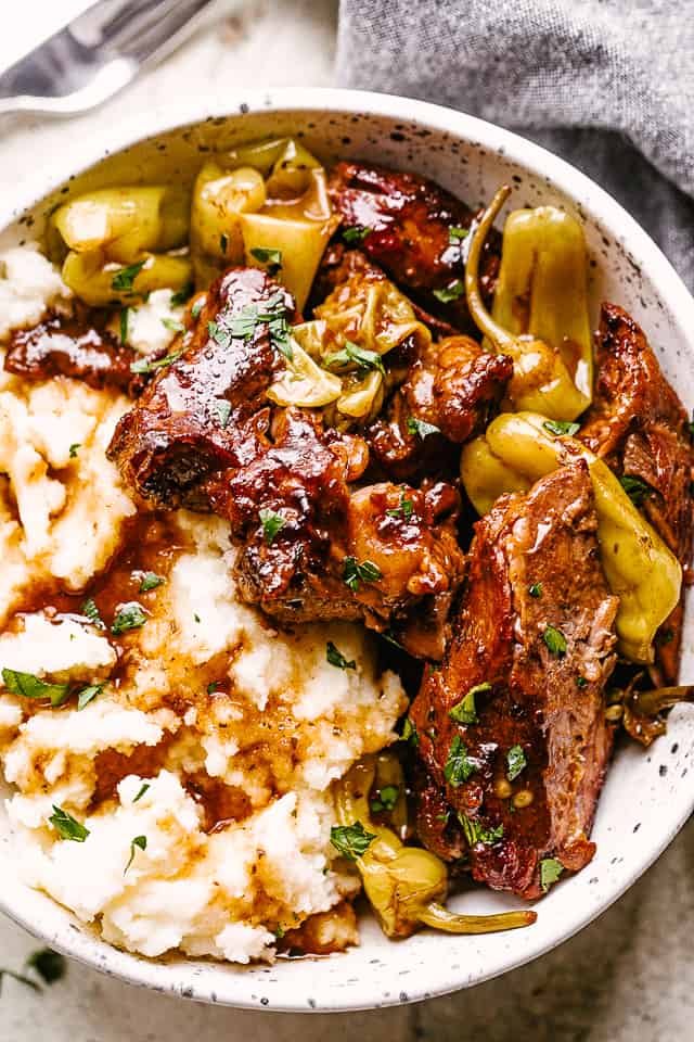 Instant pot Mississippi pot roast served with a side of mashed potatoes and pepperoncini.